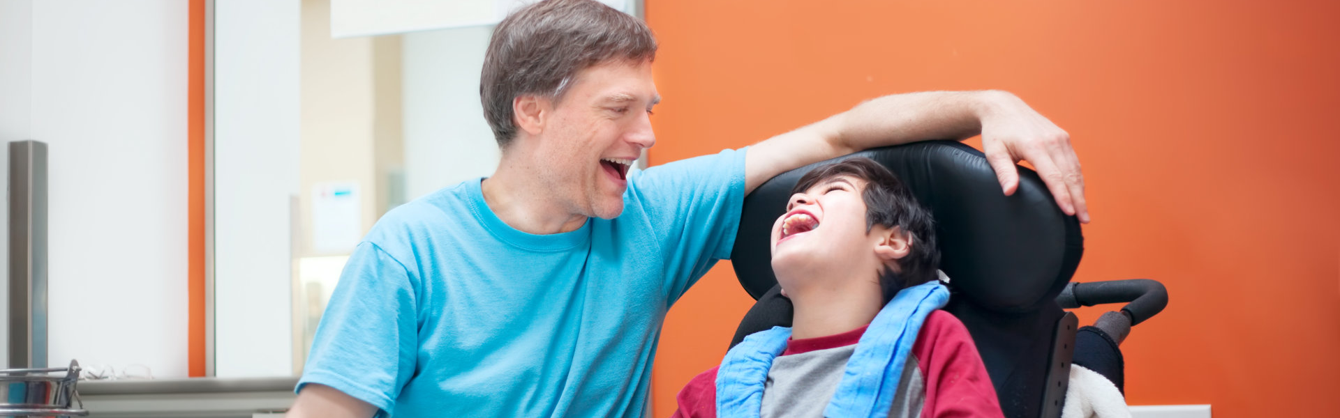 man and child laughing happily