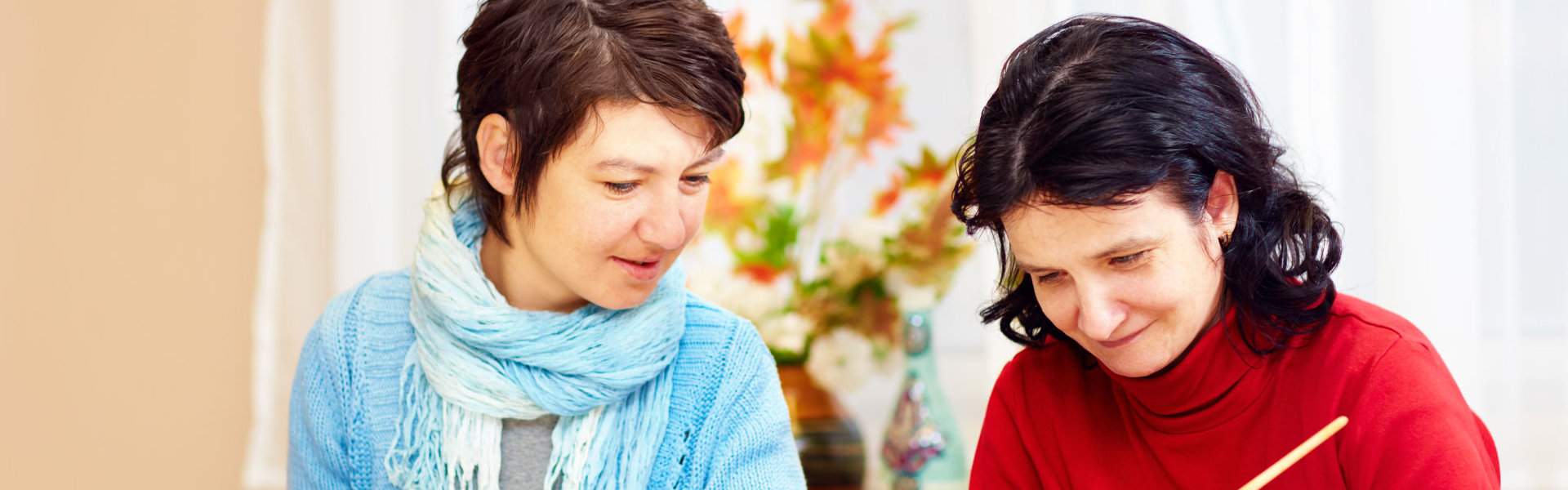 two woman writing
